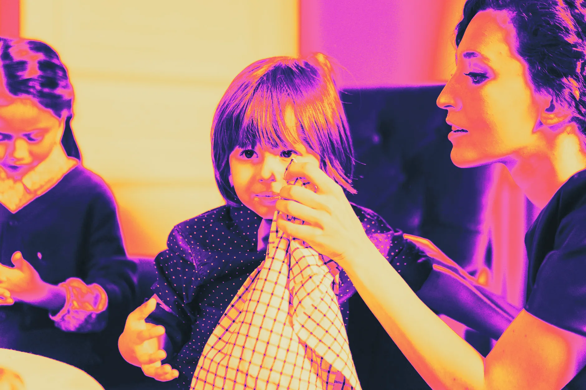 A parent gently wiping a baby's hands with a soft cloth