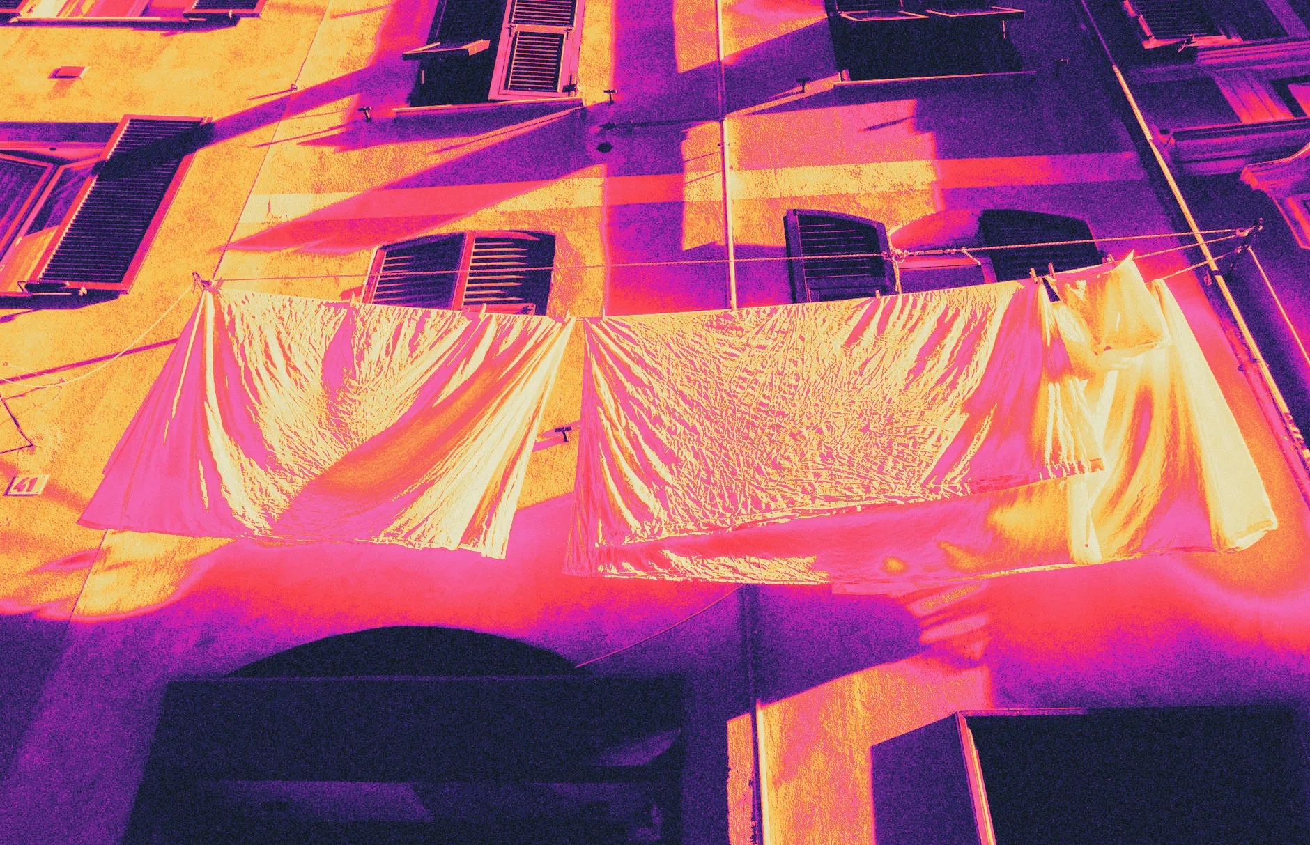 White sheets drying on a clothesline in bright sunlight