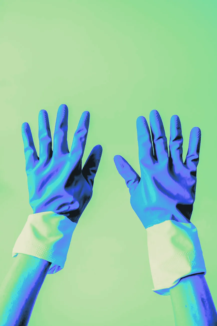 A pair of yellow rubber gloves on hands, close up
