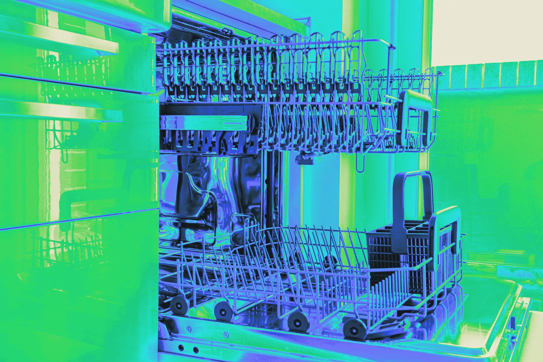 An open dishwasher with empty upper and lower racks in a sunlit kitchen