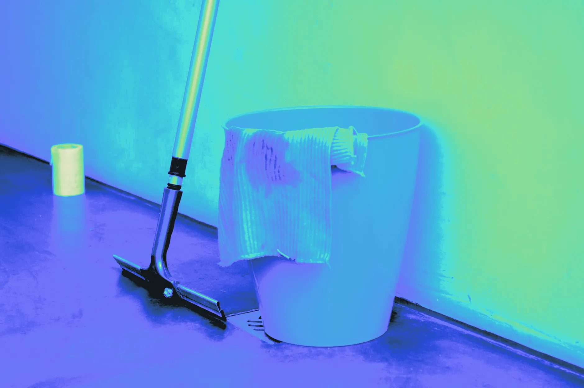 A mop and bucket beside a freshly wet floor