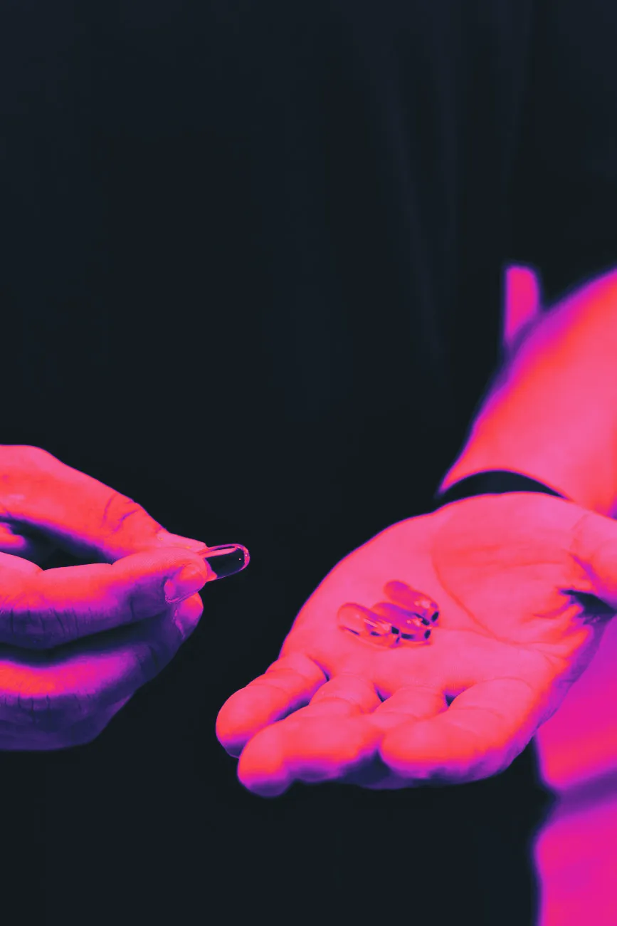 A supplement capsule held in a hand, close up