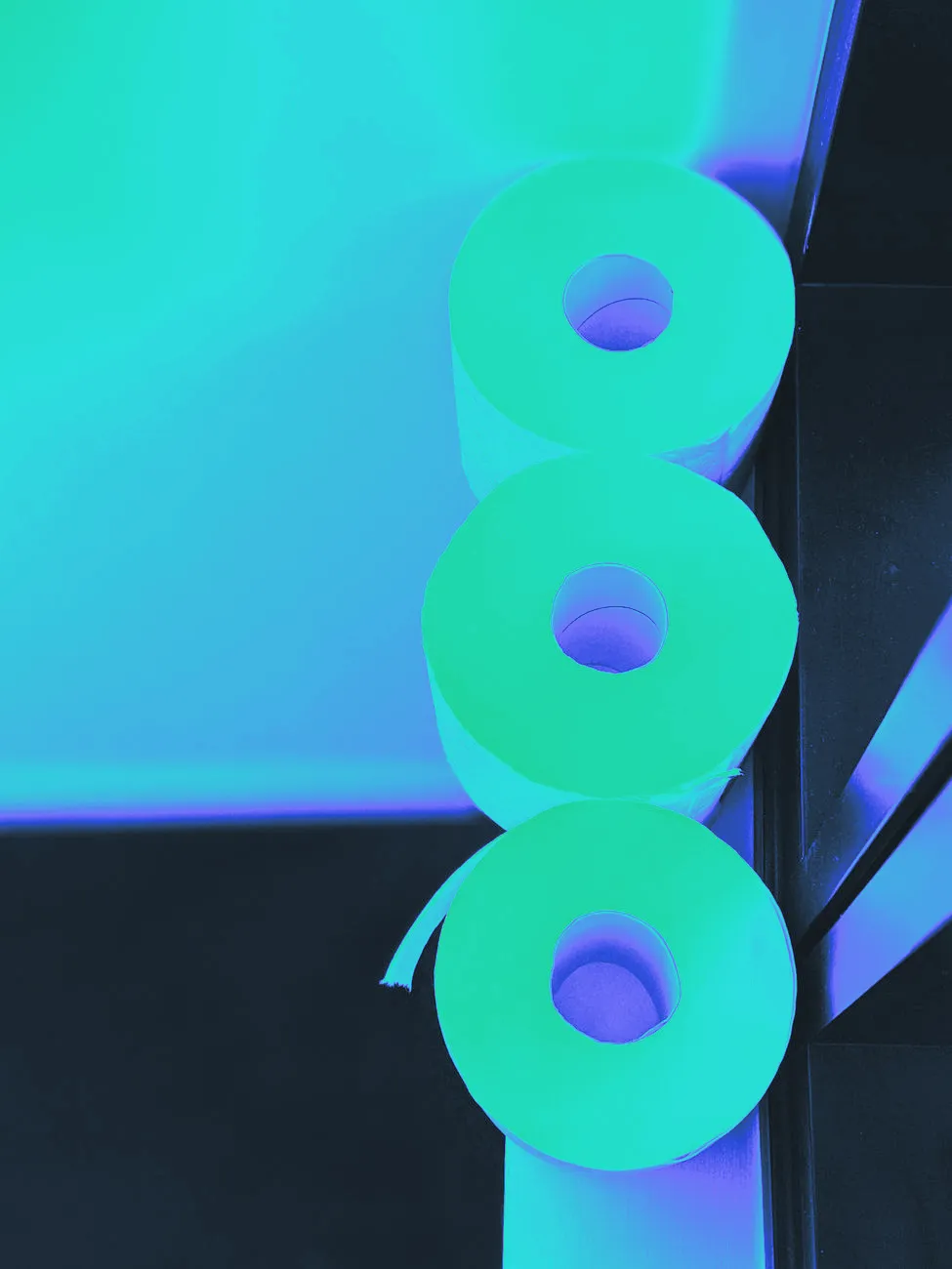A roll of toilet paper on a minimal bathroom shelf