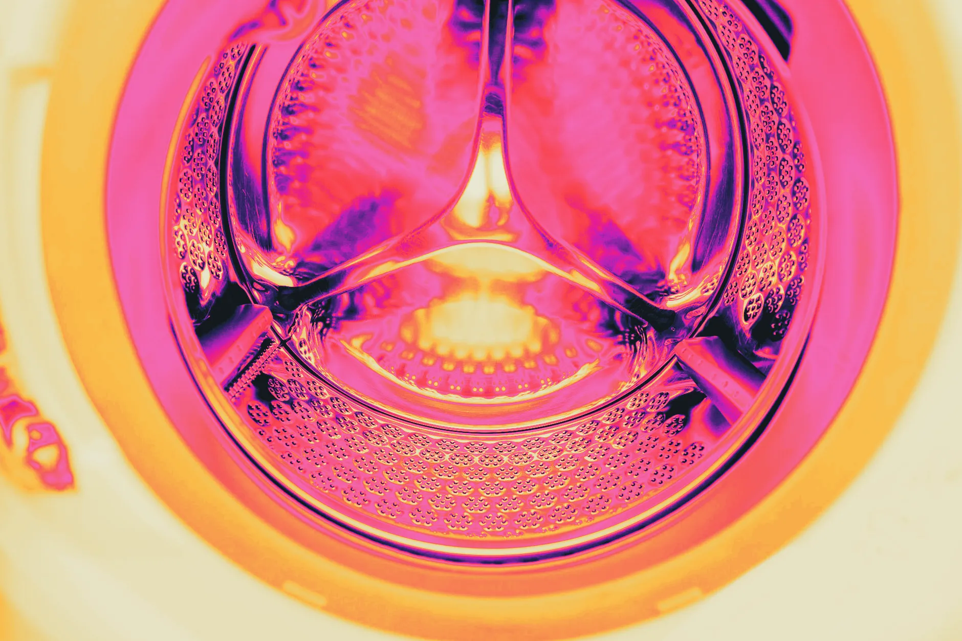 An empty washing machine drum, door open